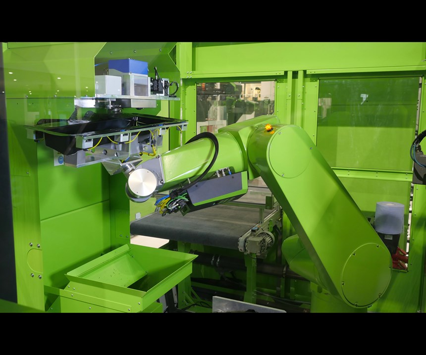 Engel’s automated cell performs laser trimming of Decoject parts after molding.