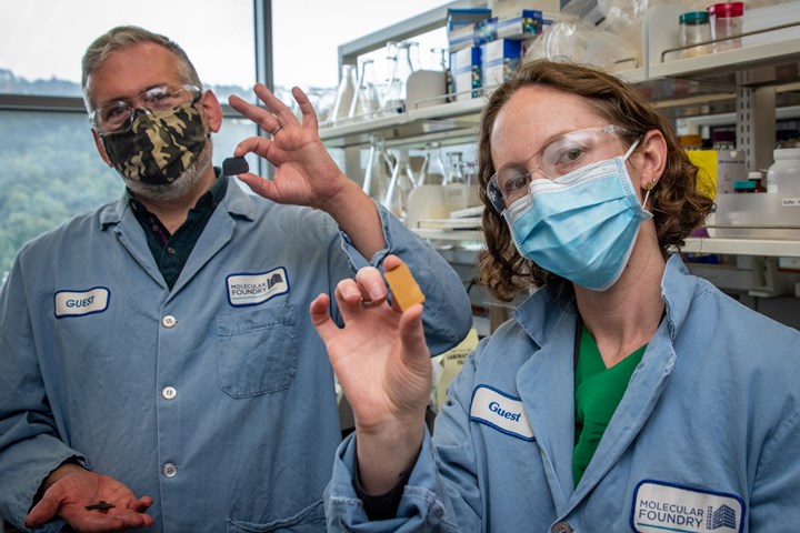 Two scientists holding pieces of PDK plastic