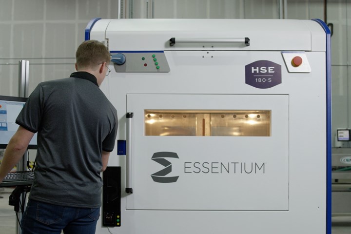 Operator looks inside Essentium printer.