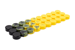 a collection of bottle caps showing the plastics color transition from black to yellow