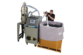 a worker using the Novatec Dryer Genie to test the moisture content in a pallet of pellets