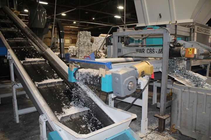 Conveyer sorting metal from plastic.
