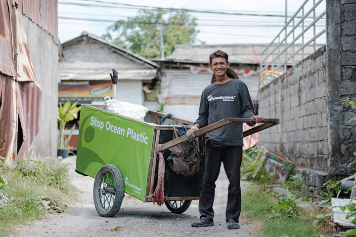 Man with cart for plastic. 