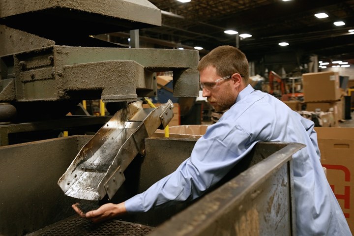 Worker inspects recycled material.