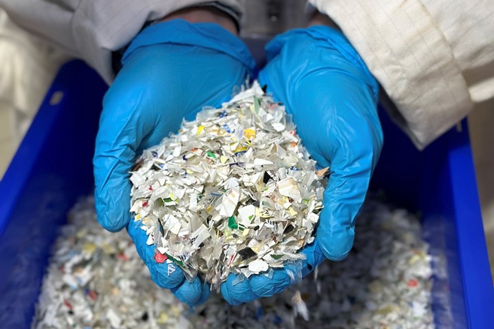 Hands holding shredded plastic.