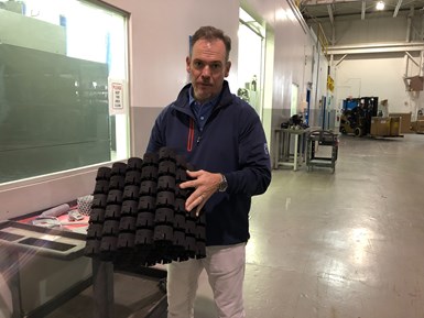 In 2020, Linear's team built this set of parts to illustrate the type of quantities Multi Jet Fusion easily makes possible. Linear founder John Tenbusch holds this batch of 120 parts which was 3D printed in about 16 hours.