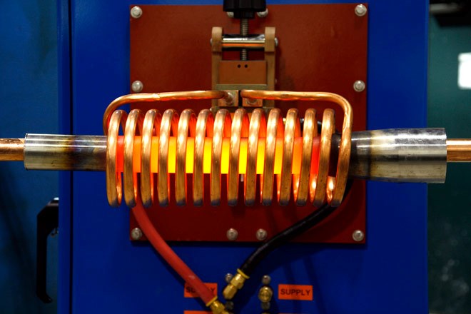 induction coil heating a piece of metal 
