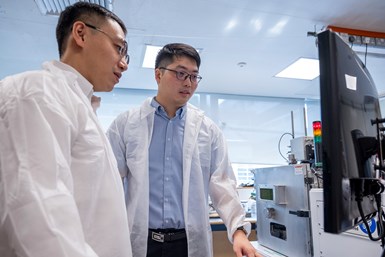 Dr Gao Shubo (left), a research fellow from NTU Singapore, and Dr. Li Zhi, a scientist from Singapore’s Agency for Science, Technology and Research, the first and second authors respectively of a study on a new method that can make customized 3D-printed metal parts containing different properties. They used the laser powder bed fusion machine (right) to 3D print the parts in their experiments. Photo Credit: NTU Singapore