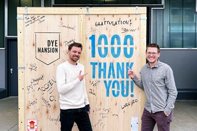 DyeMansion co-founders Philipp Kramer (CTO) and Felix Ewald (CEO) in front of the 1,000th machine, a Powerfuse S, before it was delivered to their customer Zeiss Vision Care. Photo Credit: DyeMansion