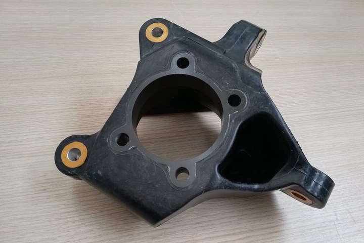 An advanced sheet compression molded suspension (ASMC) suspension steering knuckle developed by Marelli. 