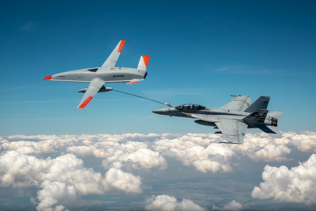 The Boeing MQ-25 T1 test asset transfers fuel to a U.S. Navy F/A-18 Super Hornet mid-air.