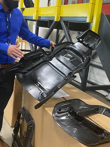 As part of IACMI Project 3.9, Dura Automotive Systems used the IACMI SURF facility’s FILL multi-layer tape laying system and Milacron injection molding machine to build preforms and prototypes of its composite seatback.