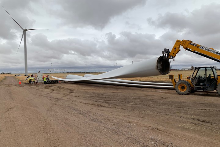 A wind turbine blade being prepared for removal after it has reached the end of its life cycle