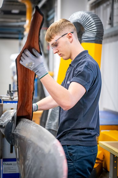 technician applying rubber boot to composite propeller blade