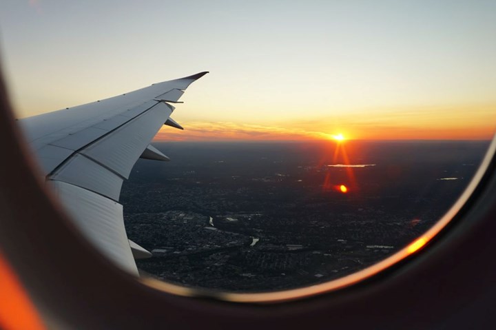 Sunset outside an airplane window.