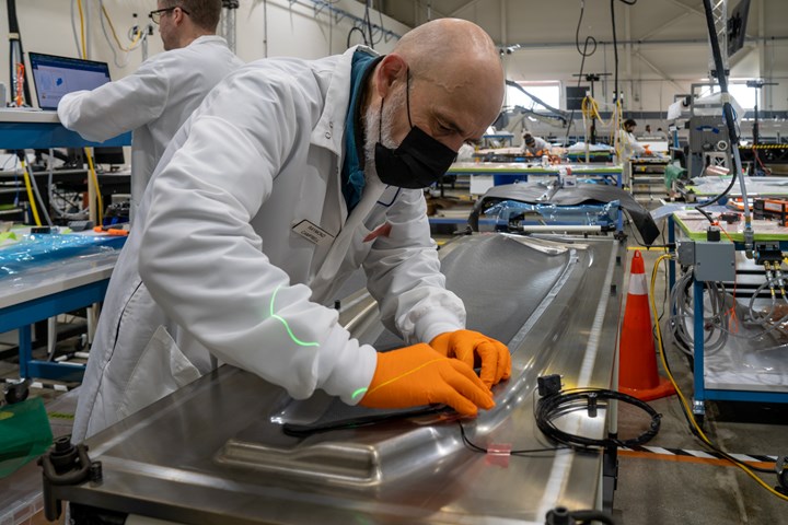 Joby Aviation plant tour, male technician performs hand layup of carbon fiber prepregs