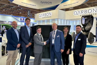Supernal and Qarbon Aerospace personnel shake hands at Paris Air Show.