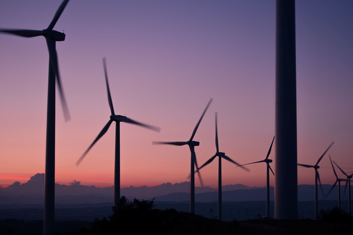 Silhouette of wind turbines during a sunrise.