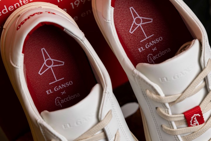 Sneakers with red soles made of recycled wind blade materials.