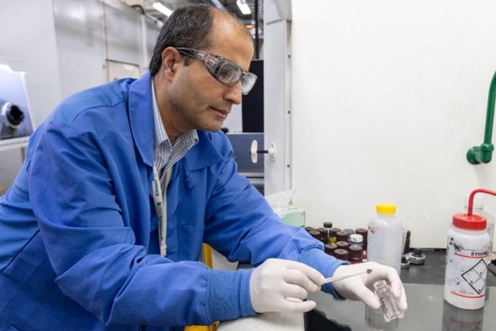 Jaswinder Sharma makes battery coin cells in the lab.