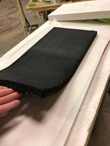 A hand manipulates a pliable sheet of VacuGrip, a porous, granular vacuum workholding material from Technical Tooling LLC. 