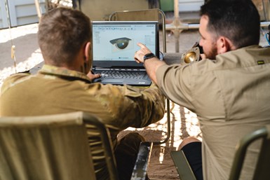 Two men in the Australian Army working at a computer.