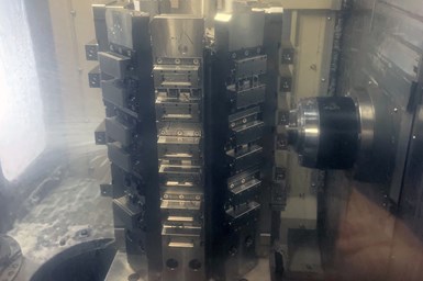 An interior image of one of Alicat's horizontal machines, showing the spindle operating on one tombstone of parts, with others to the side.