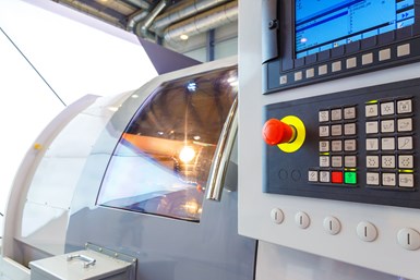 A stock photo of a CNC machine and control panel