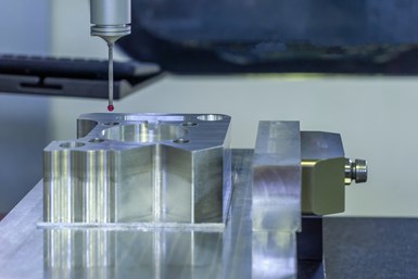 A stock photo of a CMM probe about to enter a part