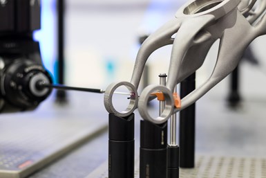A stock photo of a horizontally oriented CMM probe measuring a part.