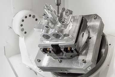 A photo of a 6061 aluminum pump housing undergoing five-axis machining operations.