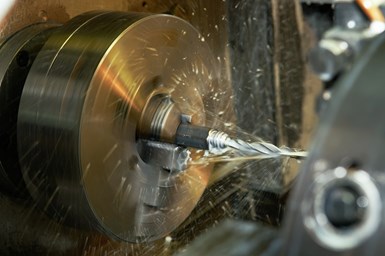 A third photo of a lathe acting on a workpiece