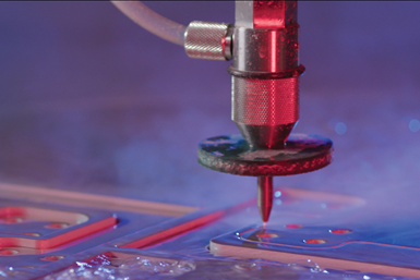 A photo of a waterjet cutter using Hypertherm's predictive waterjet pump