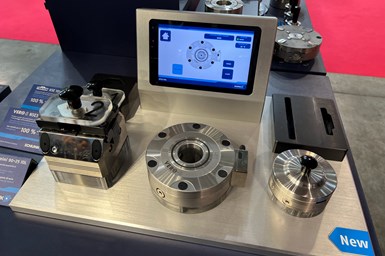 A photo of a Schunk quick-change workholding device in front of a tablet showing Schunk's detection software 
