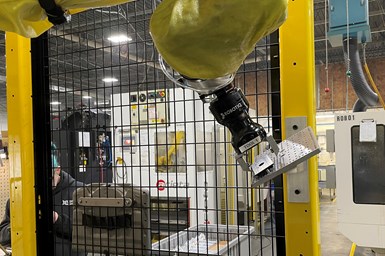 A photo of one of Wagner's cobots placing a workpiece on a tilted repositioning block mounted to the cobot frame.
