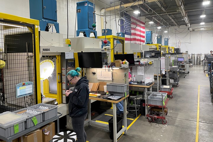 A photo of Wagner Machine's milling department, showcasing the five custom cobot frames and their FANUC RoboDrills along one wall.