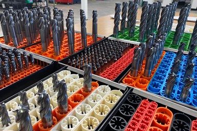 A photo of rows of different types of end mills, slotted into storage holders