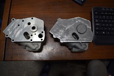 A photo of two parts made from castings, one heavily worn and the other new.