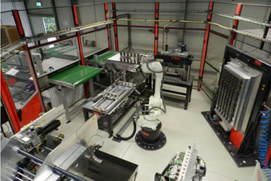 A photo of Ossenberg's automation cell with a Kawasaki RS020N robot.
