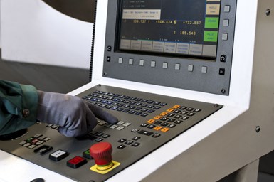 Operator hand pushing a button