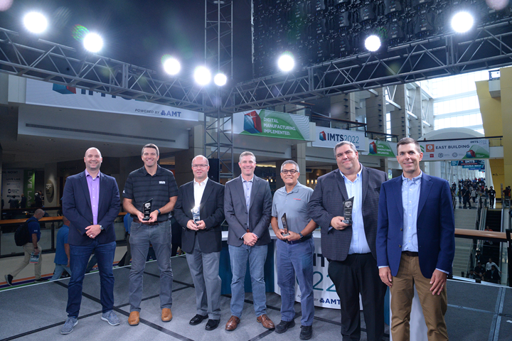Representatives from the four Top Shops honorees on stage at IMTS 2022