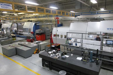 Two WFL machines on BWXT's shopfloor. Inspection tools wait in front of a barrier next to one machine.