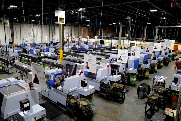 Part of the shop floor at AMPG, with Star CNC Swiss machines extending from one end to the other. Banners above each depict famous television and movie characters.