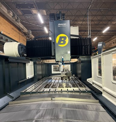 A view of Barbco's Johnford DMC-4100PH mill, looking straight across the machine table. The columns of the bridge mill almost touch the ceiling.