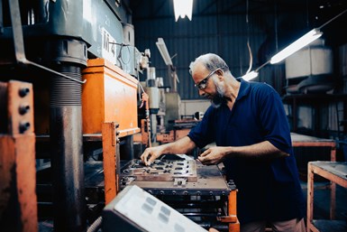 A machinist working with components