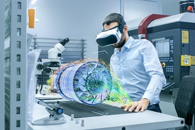 A person with a VR headset working in a machine shop.