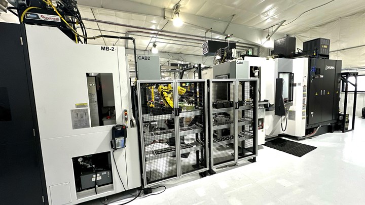 Photo of Okuma machine tools and Fanuc robots in a cell for manufacturing.