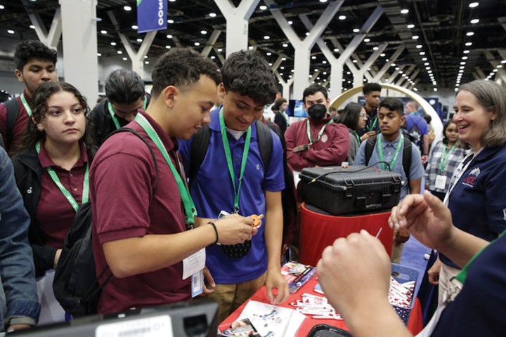 Students crowed around a booth during IMTS 2022.