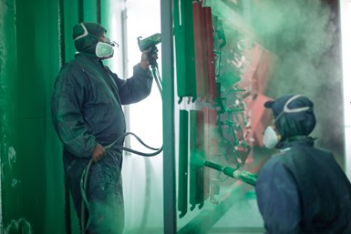 Two people working in a powder coating line.
