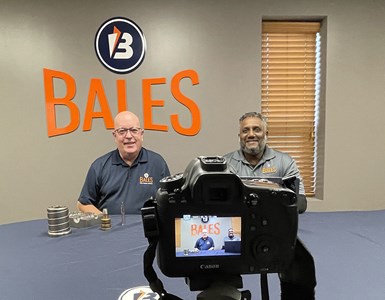 Rich Wozniak and Rich O’Brien, Bales’ technical service managers, in front of a camera.